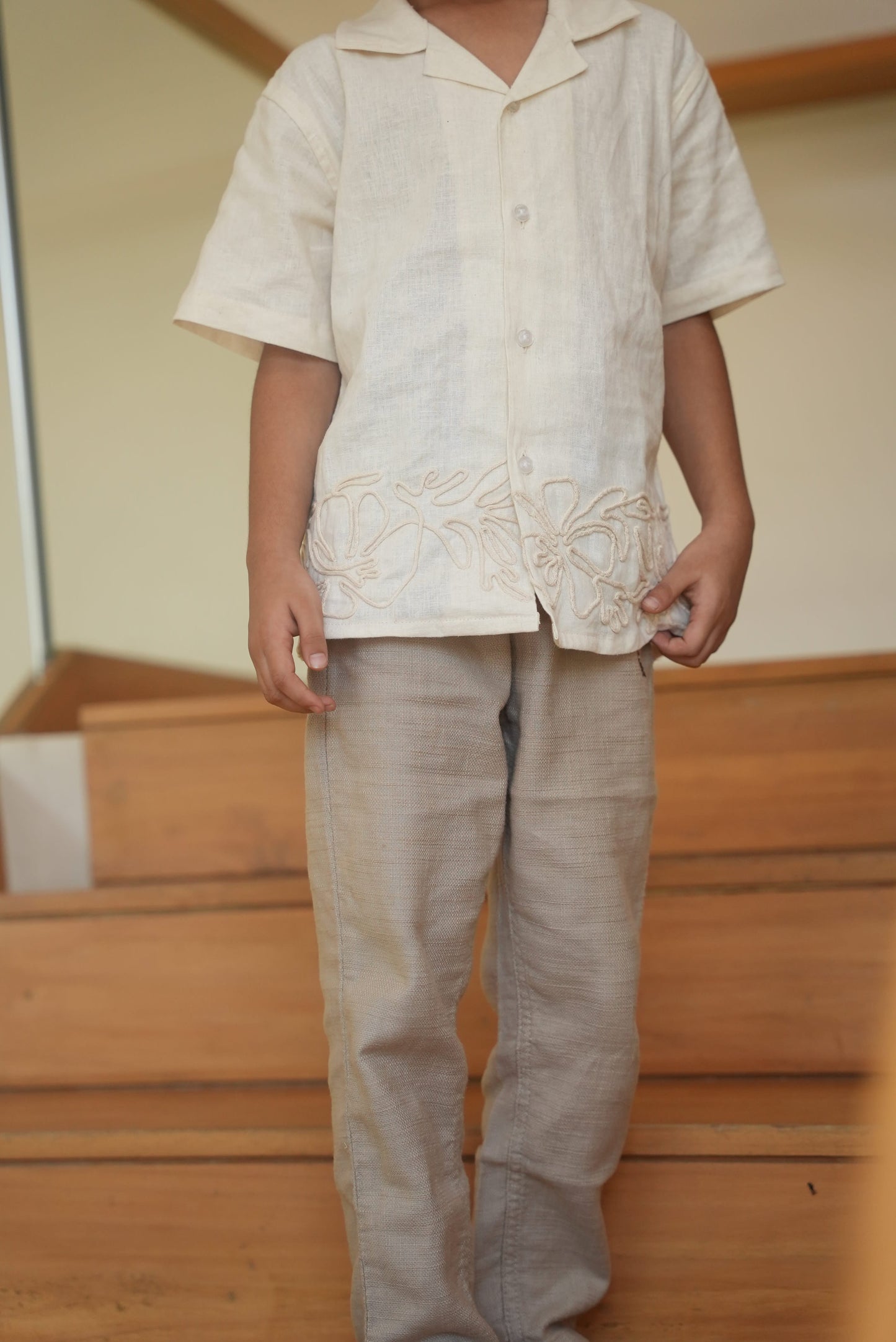 Person holding a white garment with a wooden background