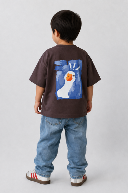 Child wearing a brown t-shirt with a colorful graphic on the back, standing against a plain background.
