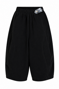 Black baggy pants with a plaid pocket on a white background