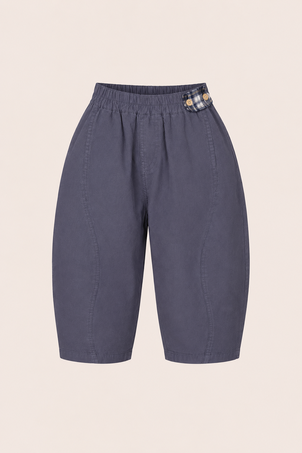 Blue kids pants with a plaid patch on a beige background