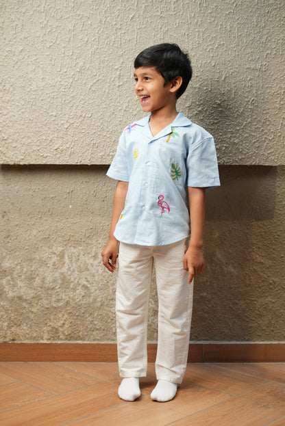 Child standing on a wooden floor with a textured wall background