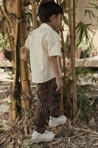 Person standing among bamboo plants in a natural setting