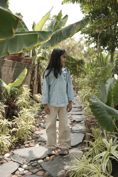 Person walking on a stone path surrounded by greenery