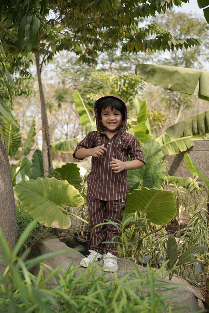 Person standing among lush green plants in a garden