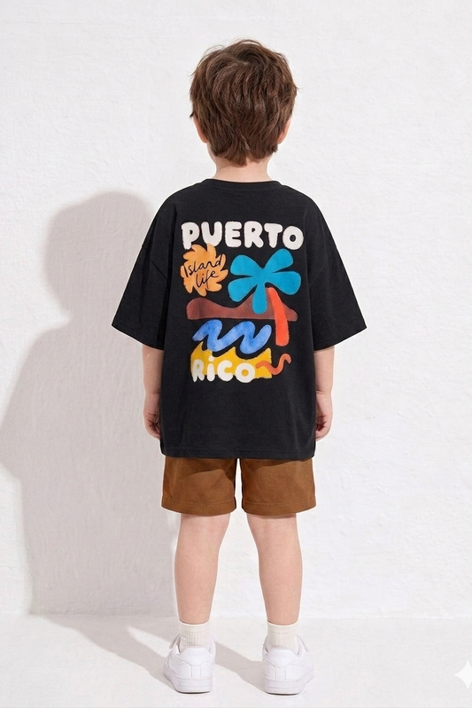Child wearing a black t-shirt with colorful graphics and text on a white background