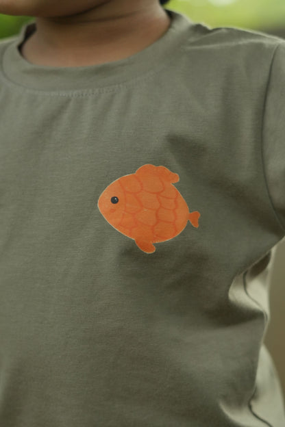 Orange fish patch on a green shirt