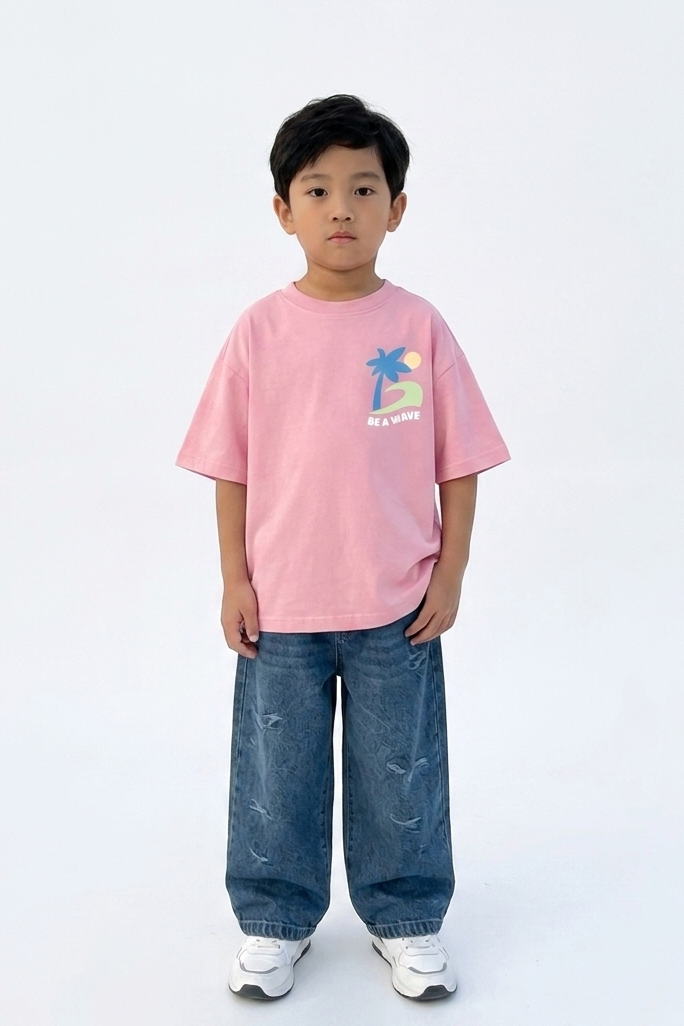 Child wearing a pink t-shirt with a graphic design and blue jeans on a white background