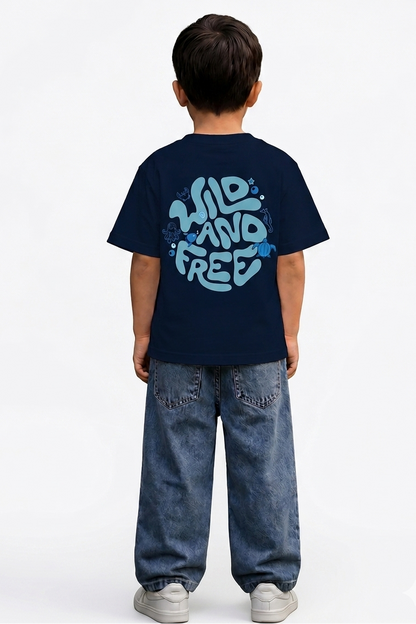 Child wearing a navy blue t-shirt with 'Wild and Free' text on the back, standing against a white background.