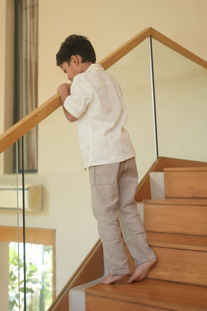Child standing on a wooden staircase indoors