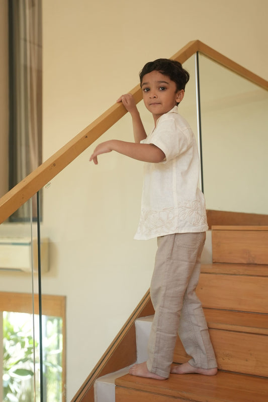 Child standing on a staircase with a glass balustrade