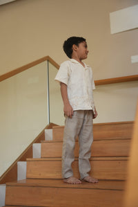 Person standing on a wooden staircase with a neutral wall background