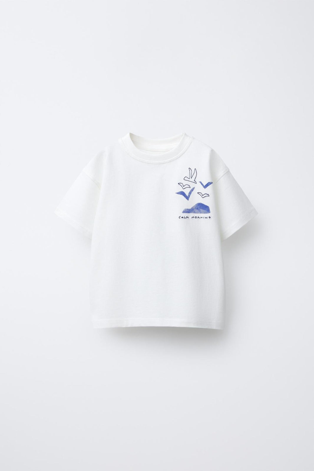 White t-shirt with blue graphic design on a white background