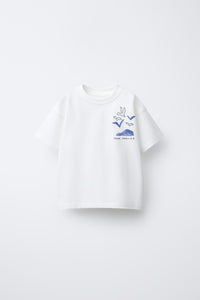 White t-shirt with blue graphic design on a white background