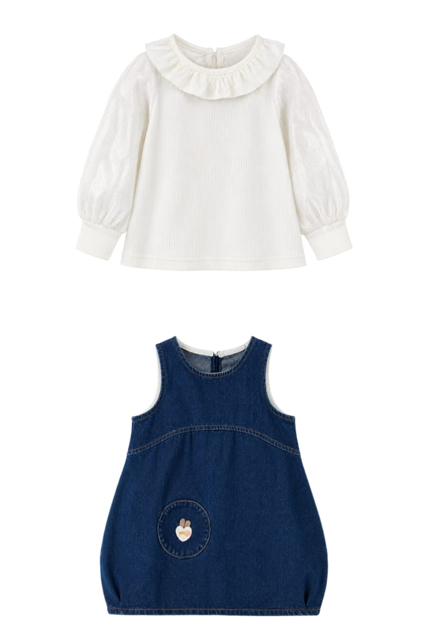 Two children's dresses shown on a plain white background: a white long-sleeve blouse with a ruffled collar and puff sleeves, and a navy sleeveless denim dress with a front patch pocket.