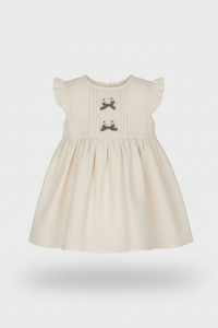 Beige dress with bow details on a white background