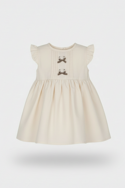 Beige dress with bow details on a white background