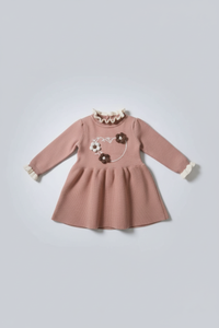 Pink dress with floral embroidery on a light gray background